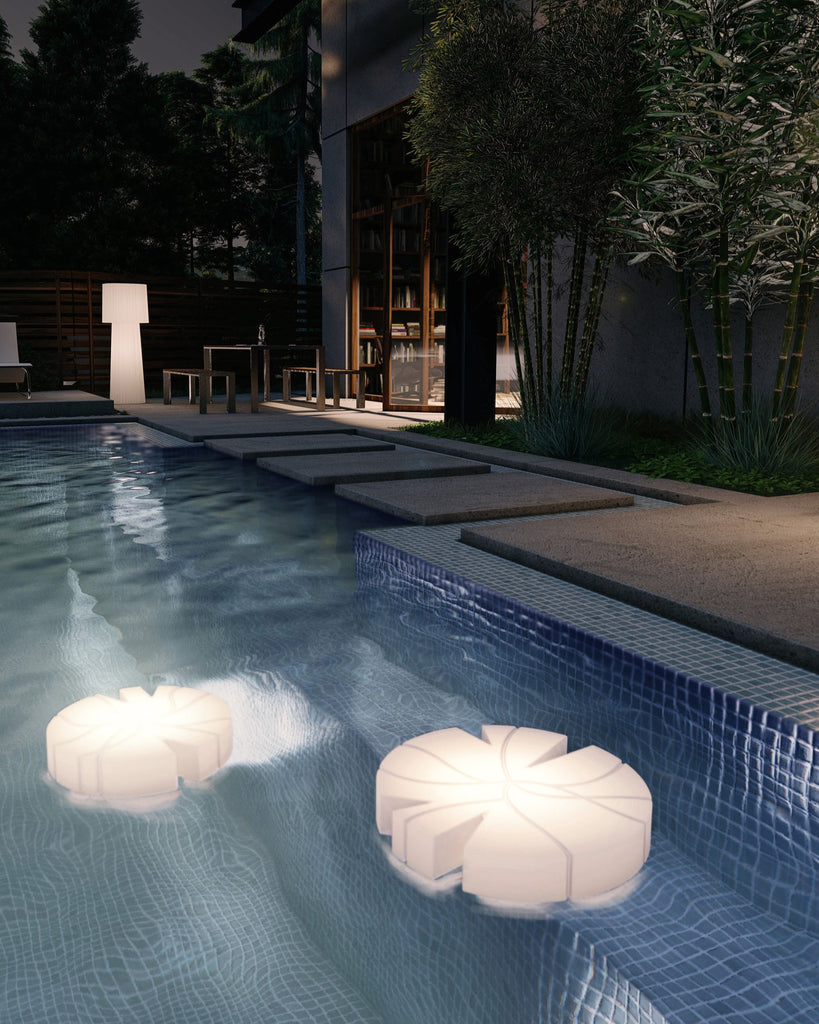 Serralunga Fiore di Loto lighted object in the shape of a lotus flower set in a swimming pool