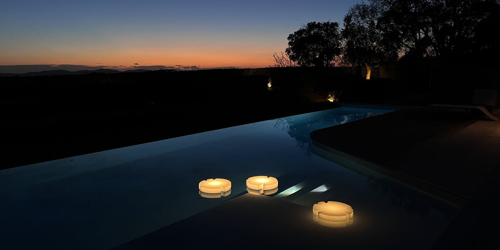 Serralunga Fiore di loto floating light in a unfinity pool with sunset